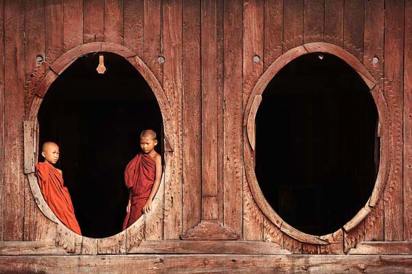 young monks at wooden doors